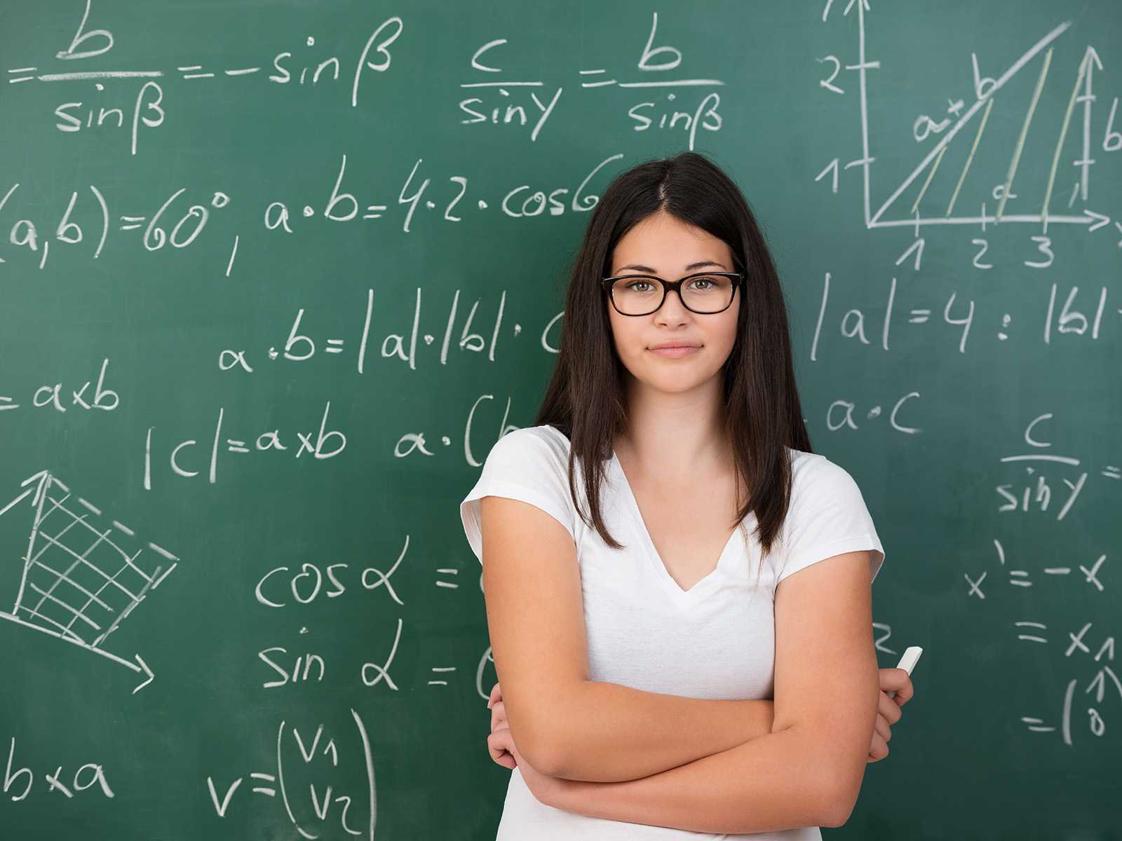 Woman in front of a chalkboard