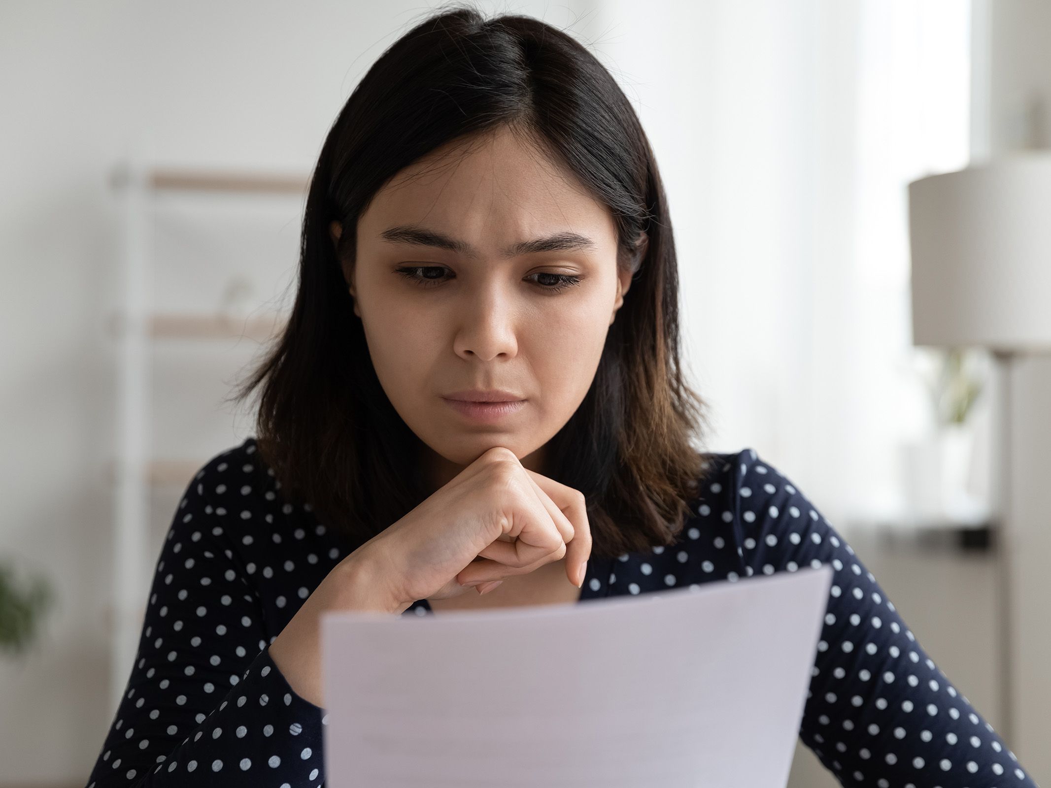 Asian American woman getting denied for a loan at the bank